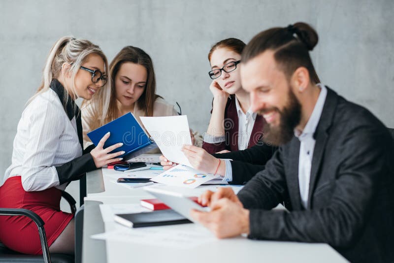 Idle employee. Team member slacking off. Smiling men browsing tablet at workplace. Idle employee. Team member slacking off. Smiling men browsing tablet at workplace.