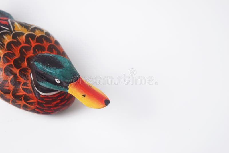 Brebes, Indonesia, June 2, 2023 : The typical Indonesian toy duck is made of wood and painted in attractive colors seen from above, Isolated White. Brebes, Indonesia, June 2, 2023 : The typical Indonesian toy duck is made of wood and painted in attractive colors seen from above, Isolated White