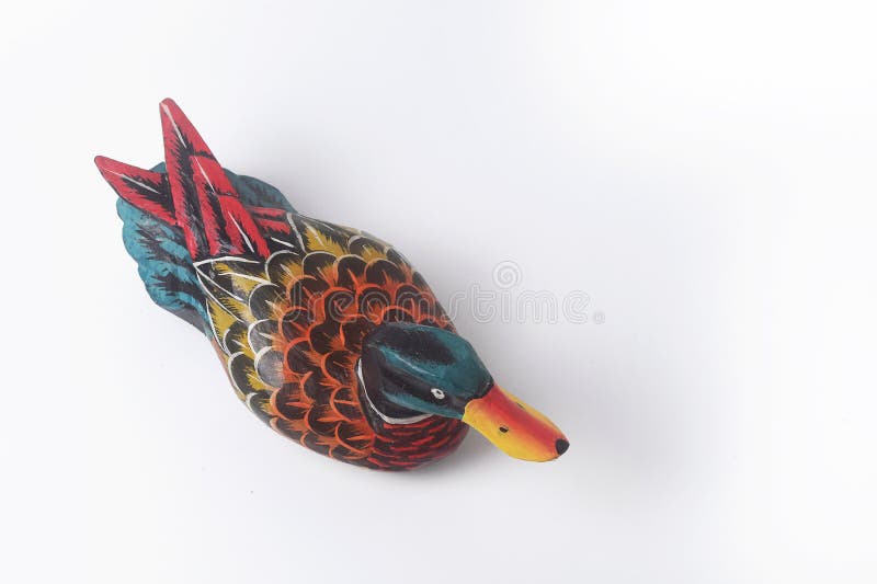 Brebes, Indonesia, June 2, 2023 : The typical Indonesian toy duck is made of wood and painted in attractive colors seen from above, Isolated White. Brebes, Indonesia, June 2, 2023 : The typical Indonesian toy duck is made of wood and painted in attractive colors seen from above, Isolated White