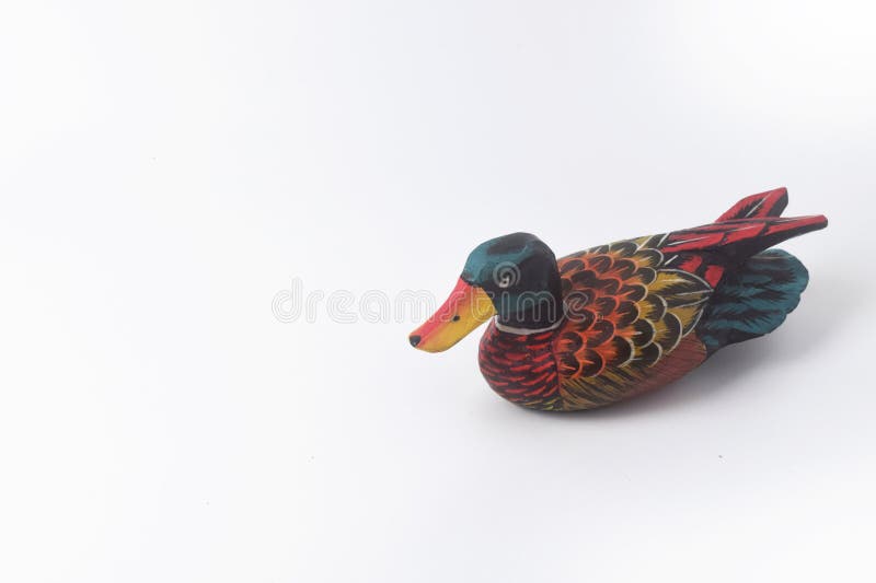 Brebes, Indonesia, June 2, 2023 : The typical Indonesian toy duck is made of wood and painted in attractive colors seen from above, Isolated White. Brebes, Indonesia, June 2, 2023 : The typical Indonesian toy duck is made of wood and painted in attractive colors seen from above, Isolated White