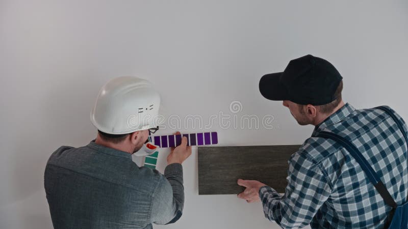 L'architetto, con l'aiuto di un ingegnere edile, seleziona materiali per la finitura degli appartamenti.. un uomo usa un video d archivio