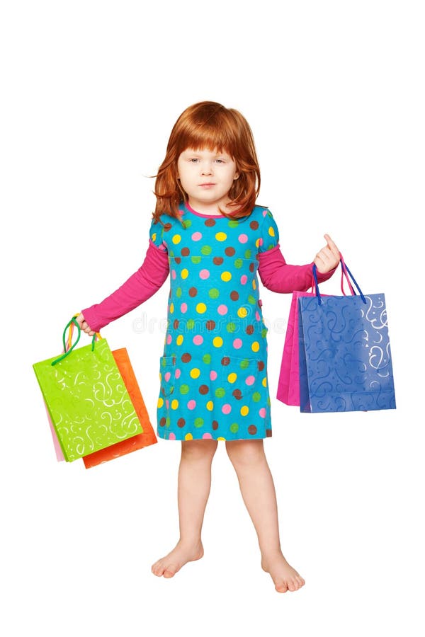 L'enfant red-haired avec des sacs à provisions image libre de droits L'enfant red-haired avec des sacs à provisions image libre de droits