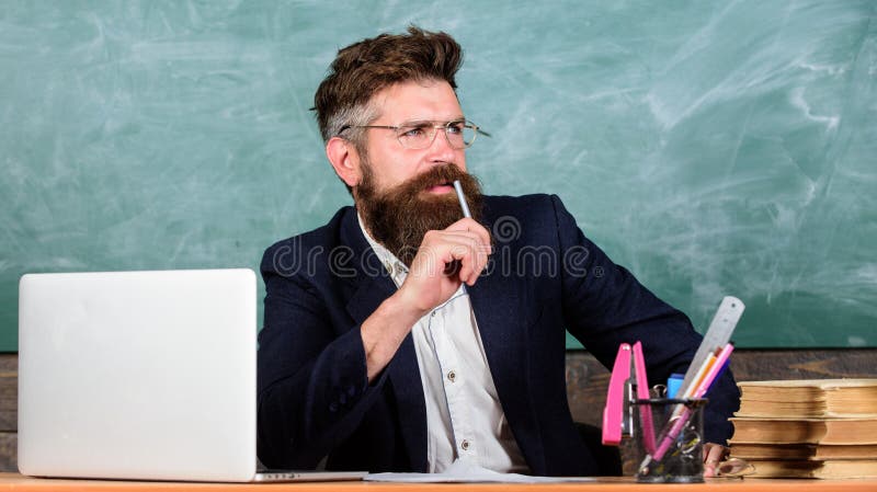 Examiner full of doubts sit at table chalkboard background. School exam concept. Tricky examinator hesitates about mark. Examiner bearded teacher with eyeglasses hesitates. Not sure in knowledge. Examiner full of doubts sit at table chalkboard background. School exam concept. Tricky examinator hesitates about mark. Examiner bearded teacher with eyeglasses hesitates. Not sure in knowledge.