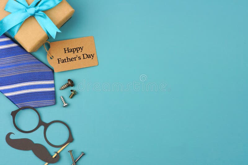 Happy Fathers Day gift tag with side border of gifts, tie and decor on a blue background. Top view with copy space. Happy Fathers Day gift tag with side border of gifts, tie and decor on a blue background. Top view with copy space.