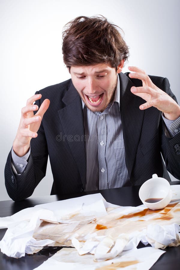 Overworked businessman spilled coffee on the very important documents. Overworked businessman spilled coffee on the very important documents