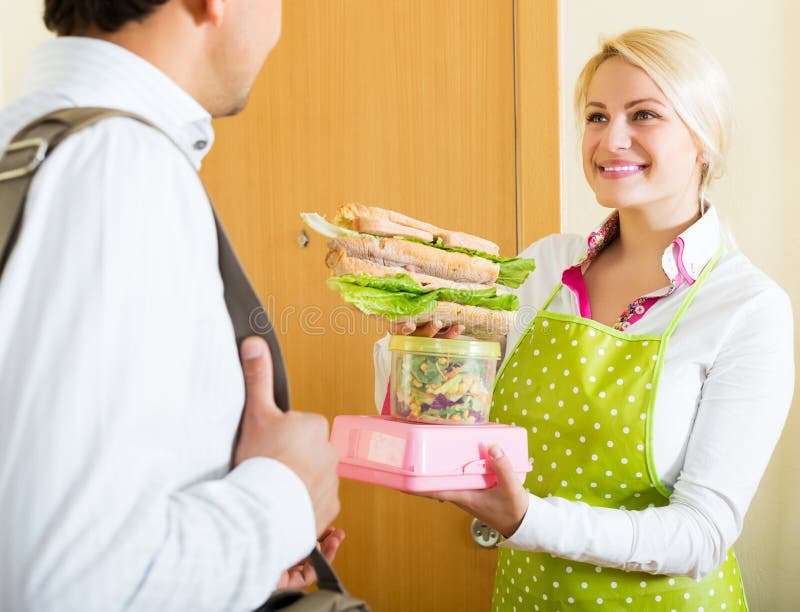 Businessman goes to work with lunch from a caring happy wife. Businessman goes to work with lunch from a caring happy wife