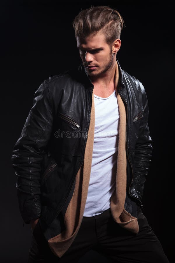 L'homme de mode dans la veste en cuir regarde en arrière au sien photos stock L'homme de mode dans la veste en cuir regarde en arrière au sien photos stock