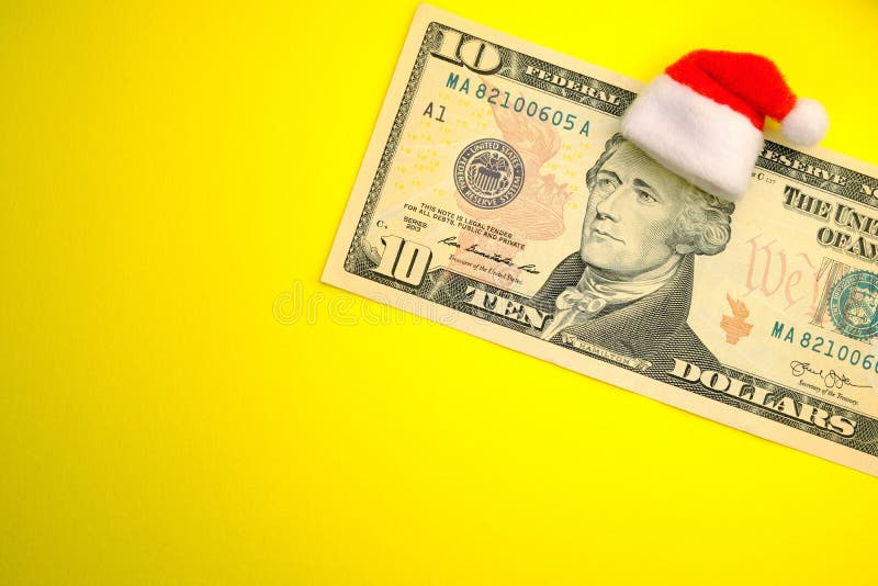 L'image de Santa Claus President Hamilton sur une facture de dollar US dix Le concept des dépenses financières pour Noël consomma image libre de droits L'image de Santa Claus President Hamilton sur une facture de dollar US dix Le concept des dépenses financières pour Noël consomma image libre de droits