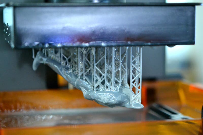 Stereolithography DPL 3d printer create detail and liquid drips, platform slowly move with liquid close-up. Progressive modern additive technology 3D printing, create scaled model by UV polymerization. Stereolithography DPL 3d printer create detail and liquid drips, platform slowly move with liquid close-up. Progressive modern additive technology 3D printing, create scaled model by UV polymerization