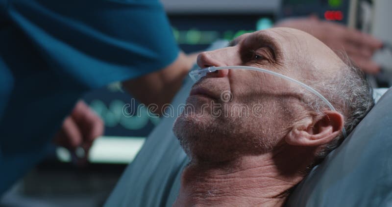 L'infermiere che dispone la cannula nasale nei pazienti fiuta immagine stock libera da diritti L'infermiere che dispone la cannula nasale nei pazienti fiuta immagine stock libera da diritti