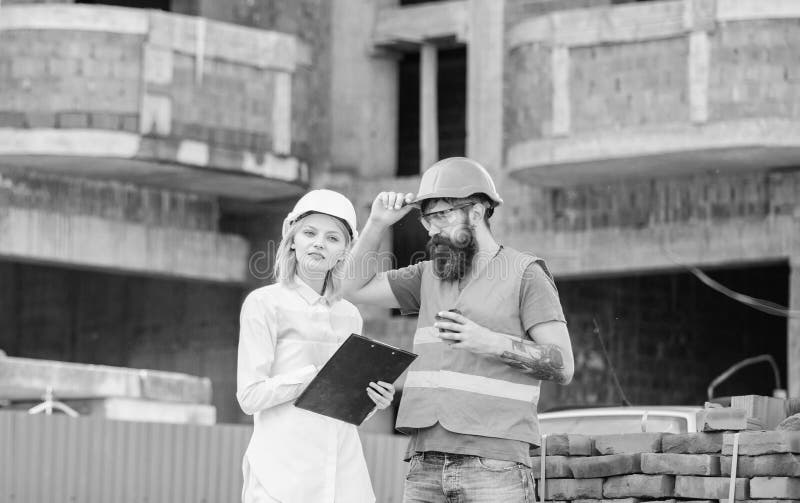L'ingénieur et le constructeur de femme communiquent au chantier de construction Discuter le plan Concept de communication d'équi image stock L'ingénieur et le constructeur de femme communiquent au chantier de construction Discuter le plan Concept de communication d'équi image stock