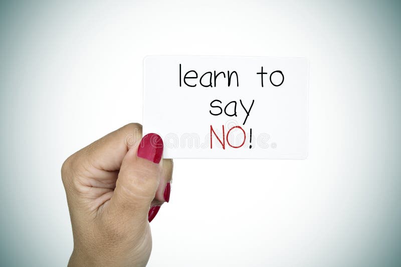 Closeup of the hand of a young woman with red polished nails holding a signboard with the text learn to say no. Closeup of the hand of a young woman with red polished nails holding a signboard with the text learn to say no