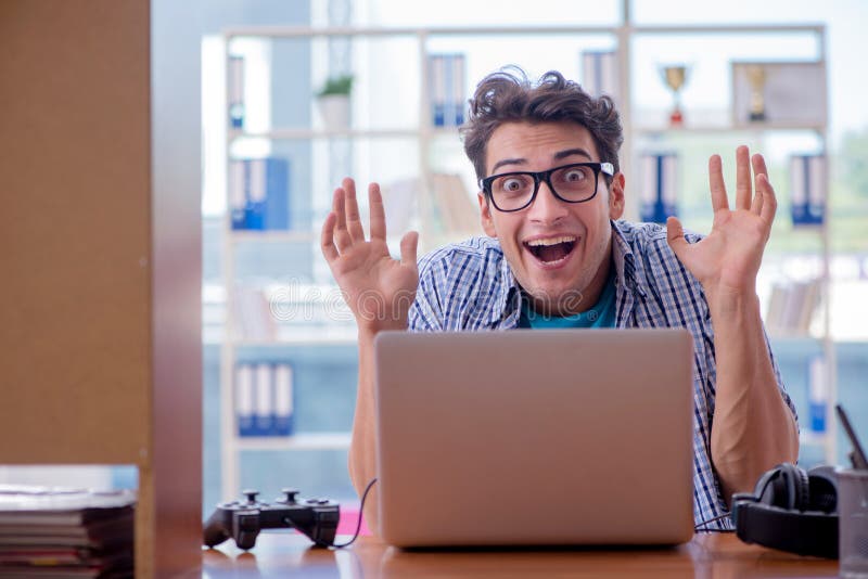L'intoxiqué de gamer jouant des jeux d'ordinateur à la maison photo stock L'intoxiqué de gamer jouant des jeux d'ordinateur à la maison photo stock