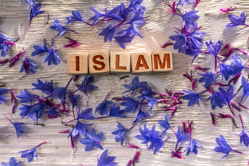 Islam written on the wooden cubes with blue flowers on white wood. Islam written on the wooden cubes with blue flowers on white wood.