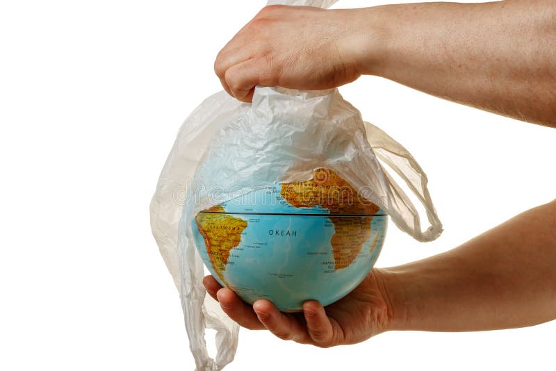 Hand man removes a plastic bag from the globe. World environment day concert. The symbol of the purification of the planet earth from dangerous toxic plastic trash. Isolated white background. Hand man removes a plastic bag from the globe. World environment day concert. The symbol of the purification of the planet earth from dangerous toxic plastic trash. Isolated white background