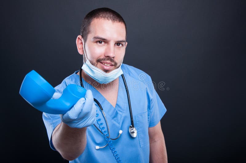 L'uso di medico sfrega passare il ricevitore telefonico e sorridere fotografie stock L'uso di medico sfrega passare il ricevitore telefonico e sorridere fotografie stock