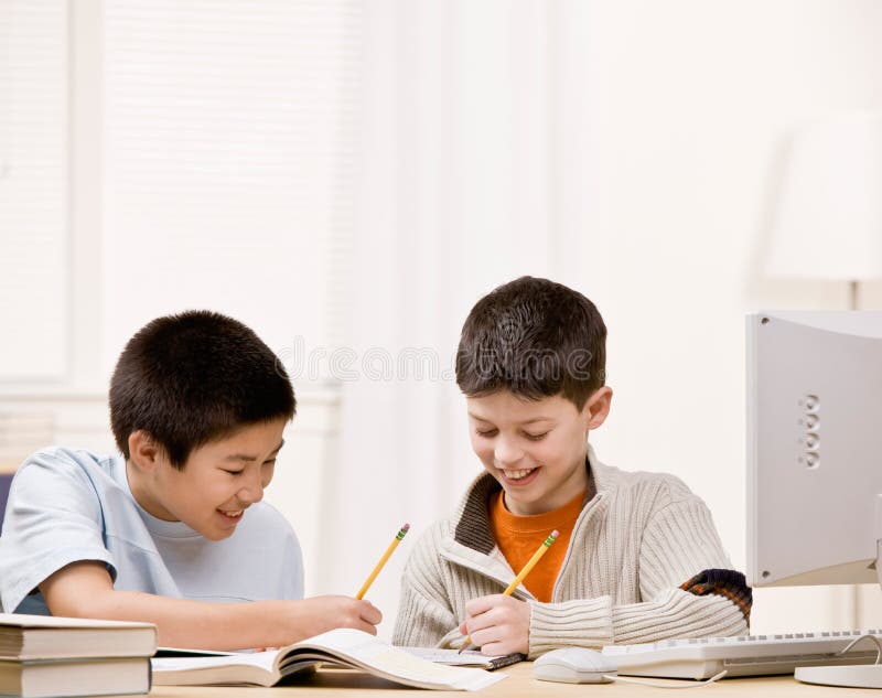 Determined student with text books helping friend do homework. Determined student with text books helping friend do homework