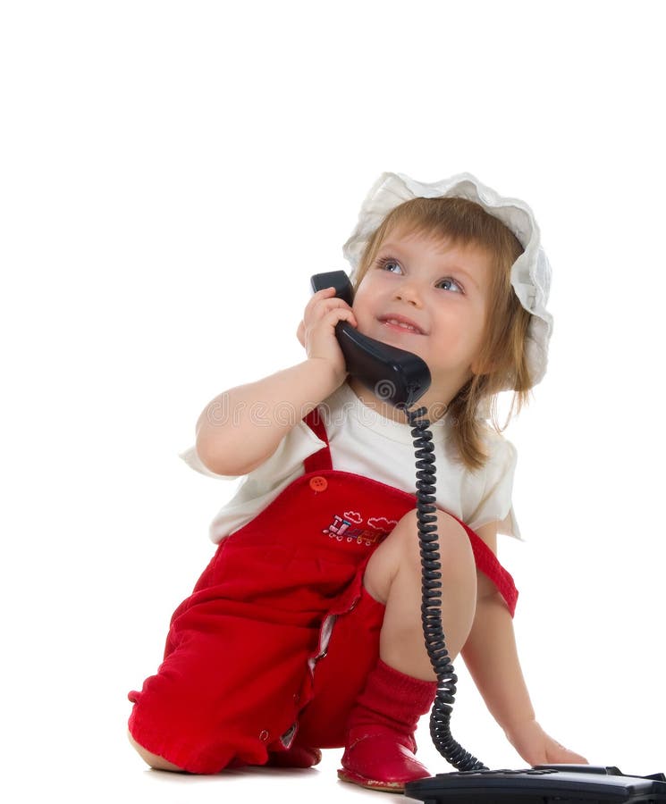 La bambina parla sul telefono fotografie stock libere da diritti La bambina parla sul telefono fotografie stock libere da diritti