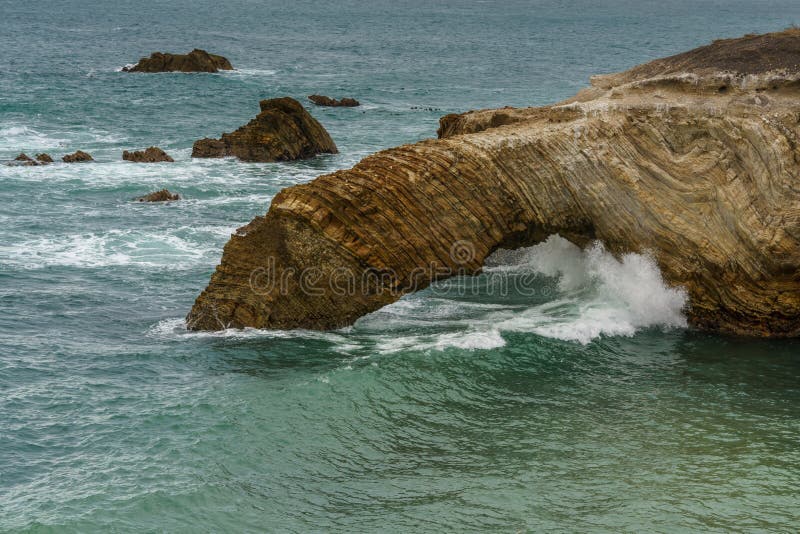 The rugged beauty of a rocky coastline meeting the vast expanse of the ocean under a dramatic sky, California Central Coast. The rugged beauty of a rocky coastline meeting the vast expanse of the ocean under a dramatic sky, California Central Coast