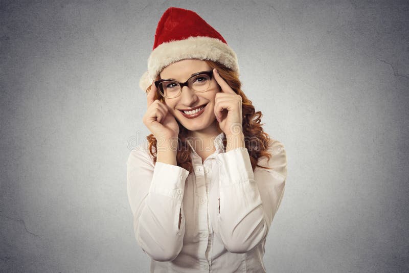 La bella giovane ragazza di natale del ritratto con i vetri che indossano il Babbo Natale copre fotografie stock libere da diritti La bella giovane ragazza di natale del ritratto con i vetri che indossano il Babbo Natale copre fotografie stock libere da diritti