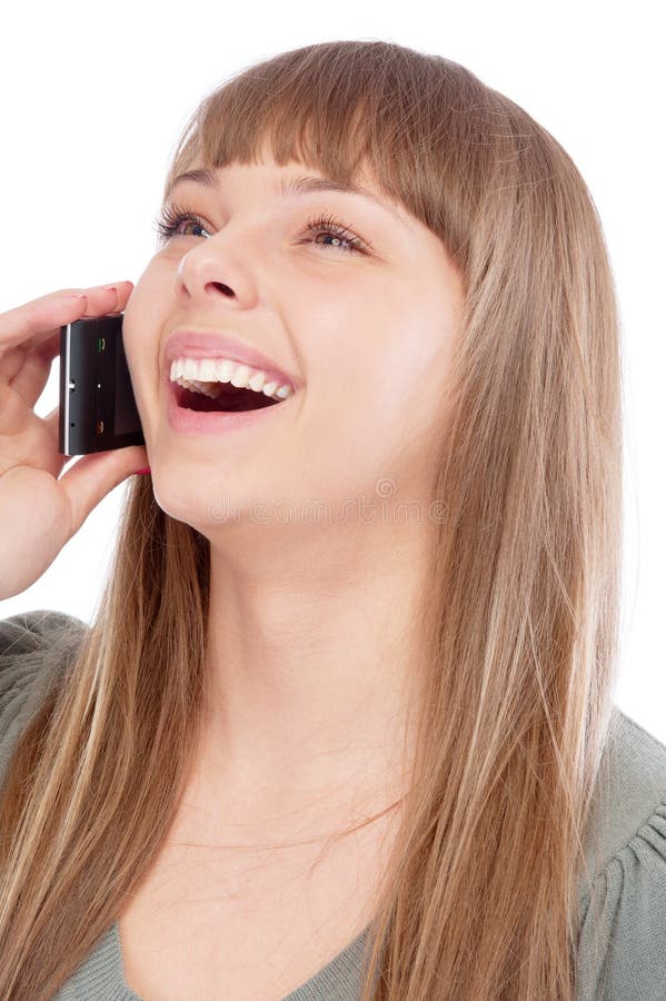 La belle fille parle par le téléphone et rit images libres de droits La belle fille parle par le téléphone et rit images libres de droits