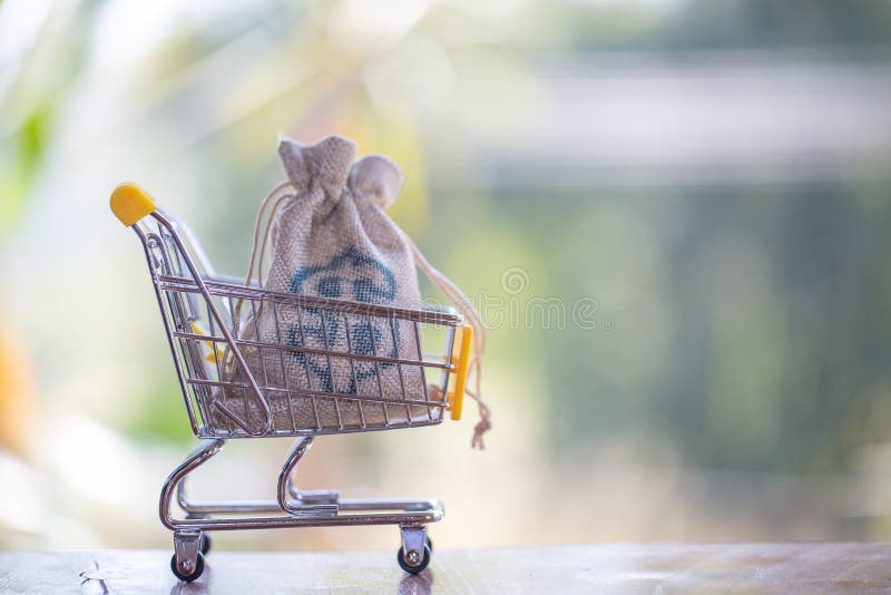 Hemp bag with silver in shopping cart, concept pay spend saving money, supermarket store, Finance and money. Hemp bag with silver in shopping cart, concept pay spend saving money, supermarket store, Finance and money.