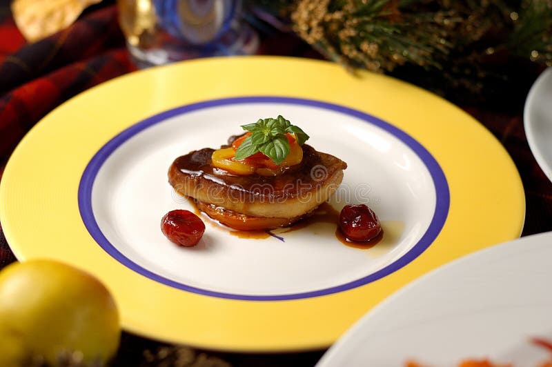 French fresh duck liver cuisine. Christmas meal. Fried foie gras with cherry sauce and figs. French fresh duck liver cuisine. Christmas meal. Fried foie gras with cherry sauce and figs