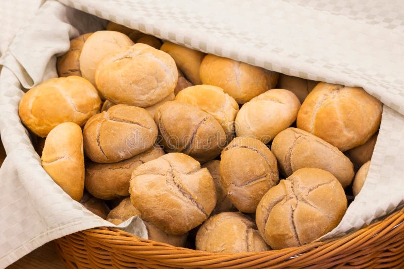 La cesta de mimbre alineó con un paño llenado de los bollos imágenes de archivo libres de regalías La cesta de mimbre alineó con un paño llenado de los bollos imágenes de archivo libres de regalías