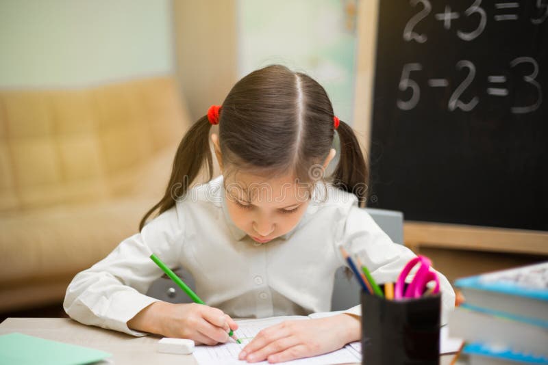 La chica joven hermosa está enseñando en casa en la pizarra Educación casera preescolar imagen de archivo libre de regalías La chica joven hermosa está enseñando en casa en la pizarra Educación casera preescolar imagen de archivo libre de regalías