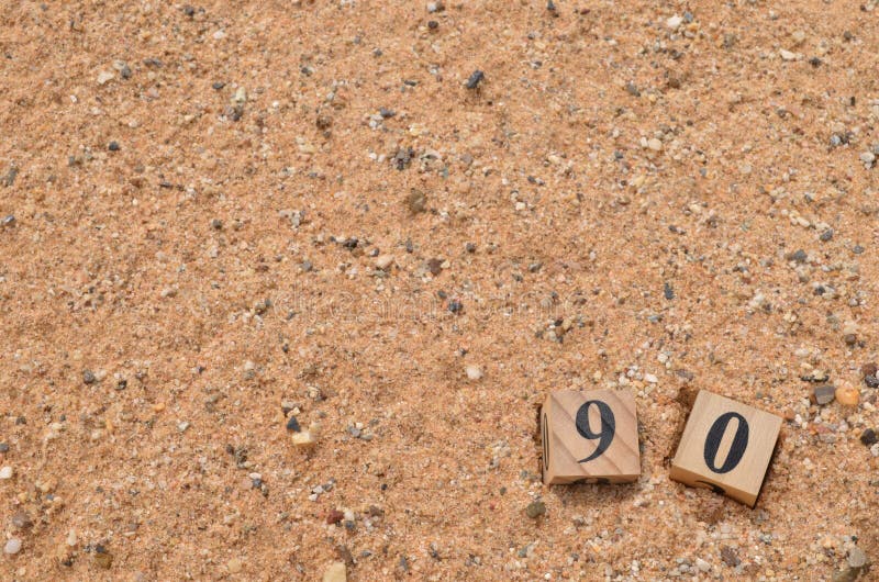 Number 90, rating, award, Empty cover design in natural concept with a number cube on sand background. Number 90, rating, award, Empty cover design in natural concept with a number cube on sand background.