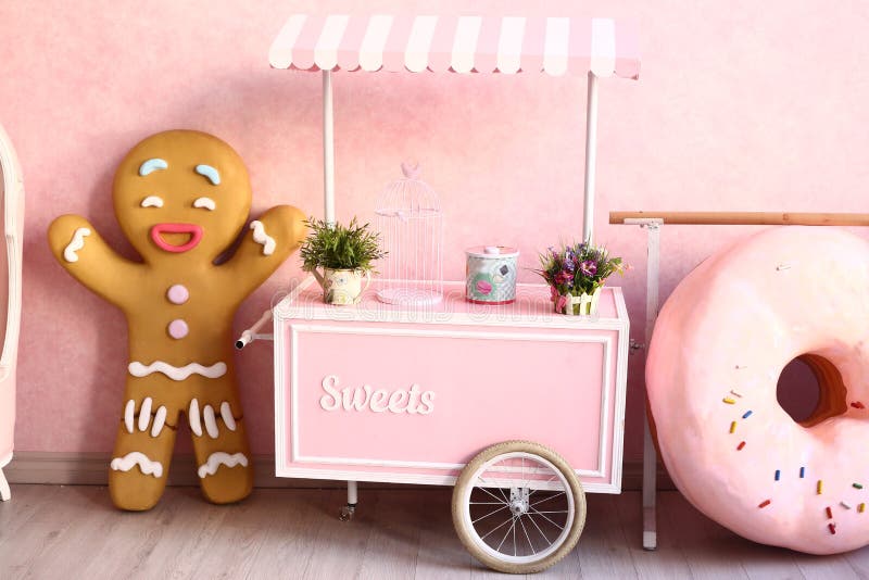 Confectionery decorated pink room with huge donut and ginger man. Confectionery decorated pink room with huge donut and ginger man