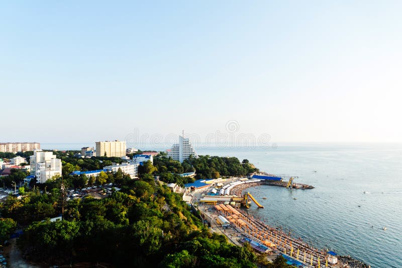 The coast of Anapa from a height. View of the calm Black Sea, the stone beach High Coast, the sanatorium, and the old part of the city. Summer at the resort. The coast of Anapa from a height. View of the calm Black Sea, the stone beach High Coast, the sanatorium, and the old part of the city. Summer at the resort