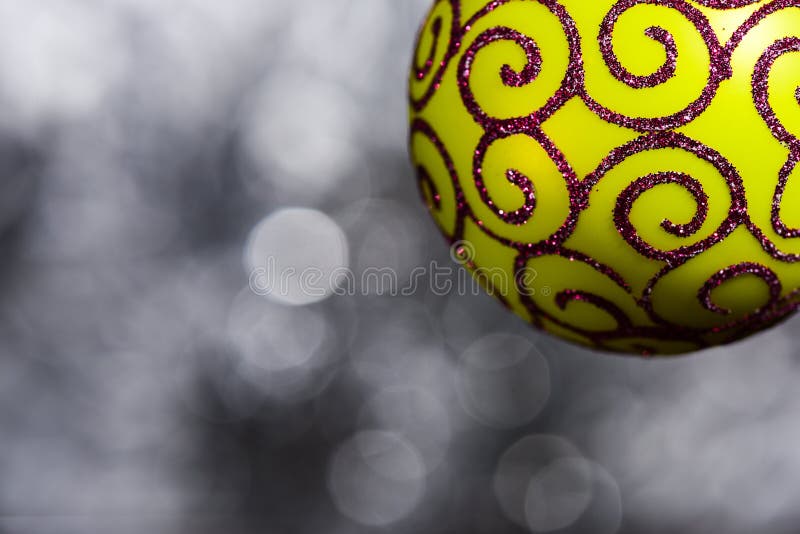 La decoración festiva para el árbol de navidad, bola amarilla con la decoración del brillo en gris empañó el fondo, cierre para a imágenes de archivo libres de regalías La decoración festiva para el árbol de navidad, bola amarilla con la decoración del brillo en gris empañó el fondo, cierre para a imágenes de archivo libres de regalías