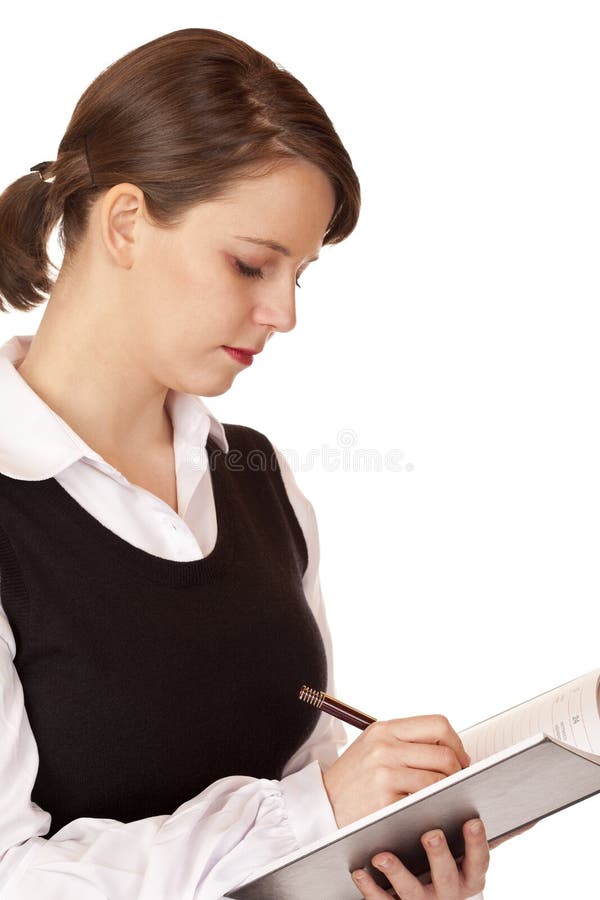 La donna di affari scrive in blocchetto per appunti immagine stock La donna di affari scrive in blocchetto per appunti immagine stock