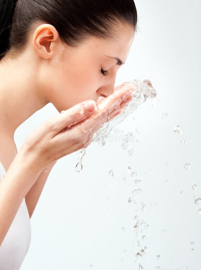 Woman wash her face with water, close-up, side view. Woman wash her face with water, close-up, side view