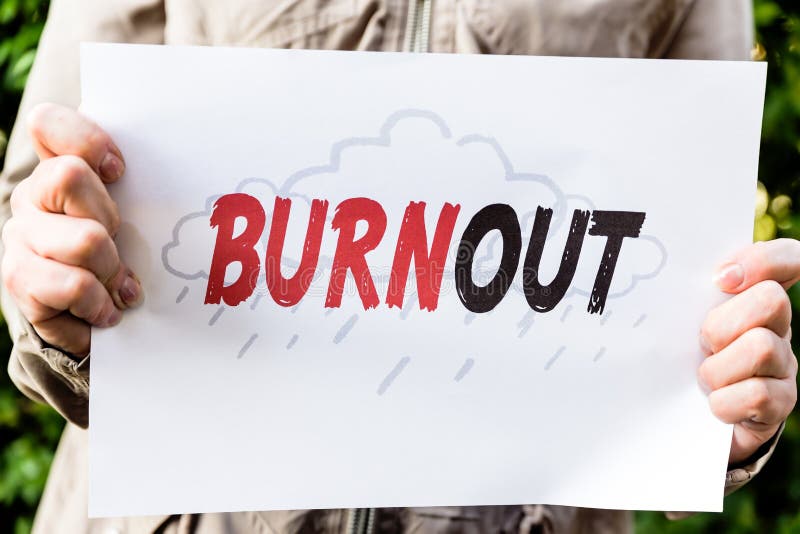 La donna sta tenendo una carta con burnout di parola fotografie stock libere da diritti La donna sta tenendo una carta con burnout di parola fotografie stock libere da diritti