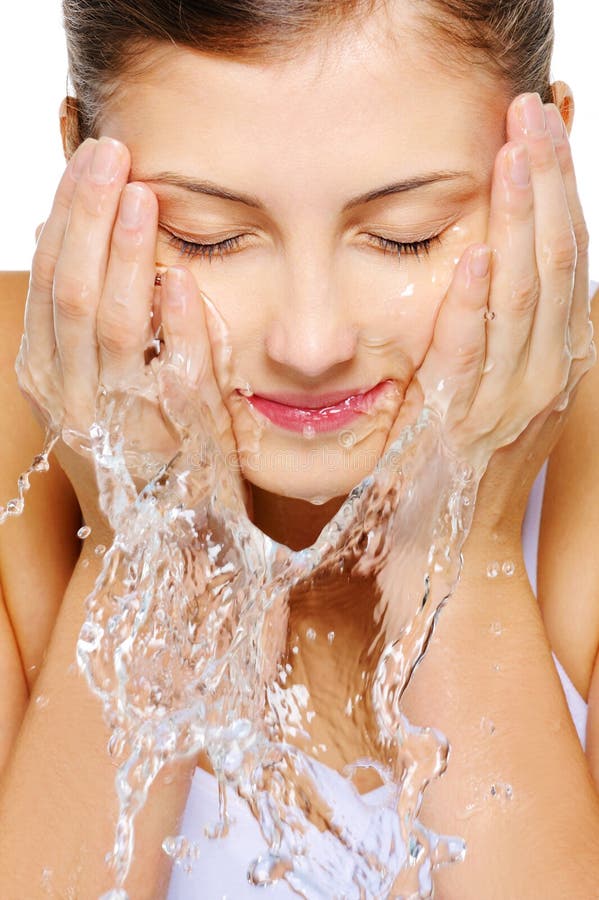 Close-up portrait of a cute young woman wash her face with water. Close-up portrait of a cute young woman wash her face with water