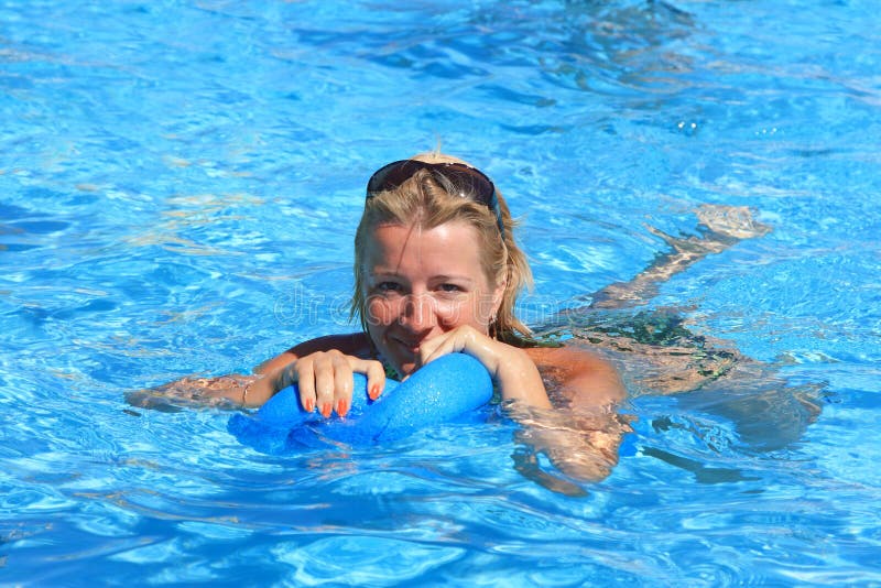 La donna è agganciata nel aerobics in acqua
