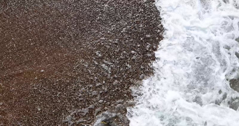 La espuma en la orilla del mar y las pequeñas olas