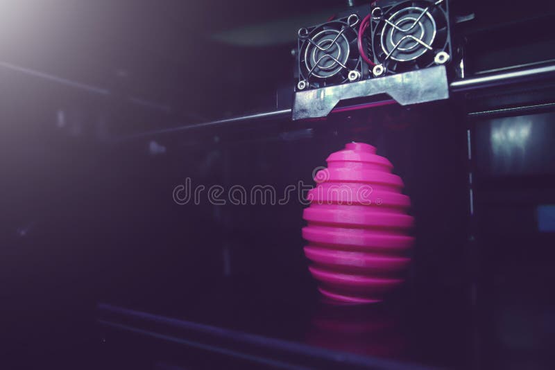 FDM 3D-printer manufacturing wound pink easter egg sculpture - wide angle view on object, print head and machine chamber- matte dark futuristic light mood- background blanked out blurry. FDM 3D-printer manufacturing wound pink easter egg sculpture - wide angle view on object, print head and machine chamber- matte dark futuristic light mood- background blanked out blurry