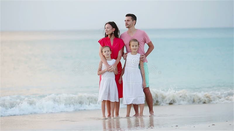 La famille heureuse avec des enfants marchent sur la plage banque de vidéos