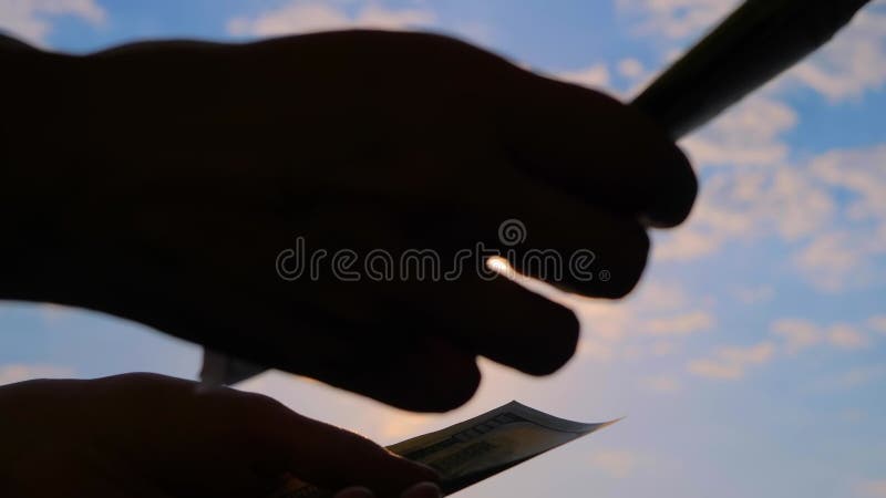La femme prend et compte des dollars contre le ciel couché de soleil près banque de vidéos