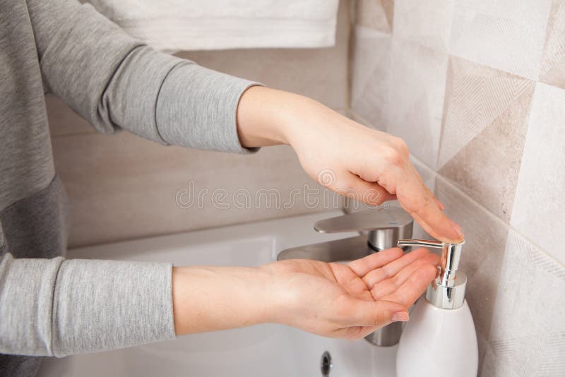 Woman picks up liquid soap on her hands. Hand disinfection. Prevention and protection of health during the coronavirus pandemic. Woman picks up liquid soap on her hands. Hand disinfection. Prevention and protection of health during the coronavirus pandemic.