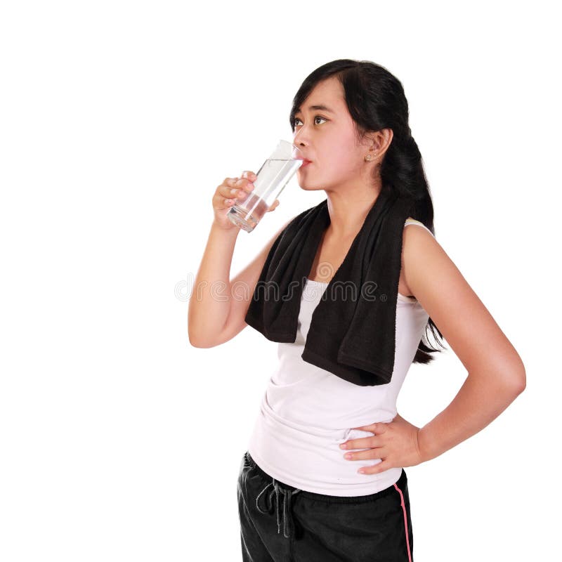 La femme sportive buvant un verre de l'eau a isolé le portrait photos libres de droits La femme sportive buvant un verre de l'eau a isolé le portrait photos libres de droits