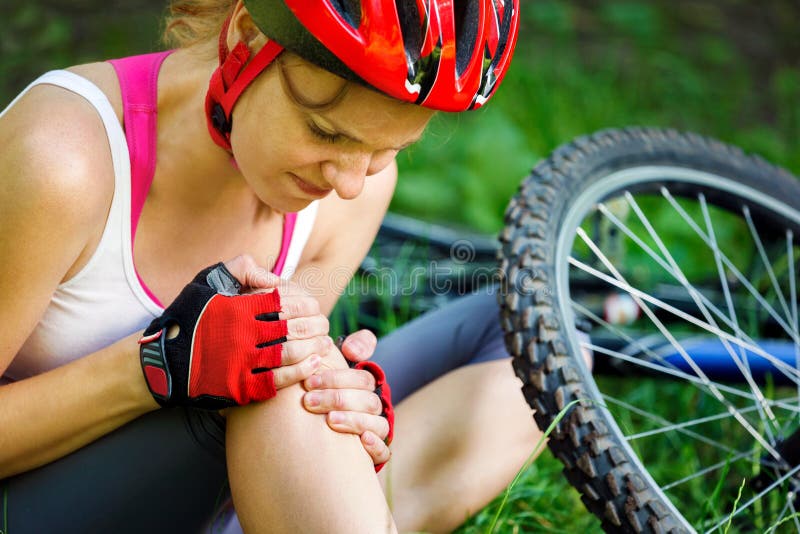 Young woman fell off mountain bike. Young woman fell off mountain bike.