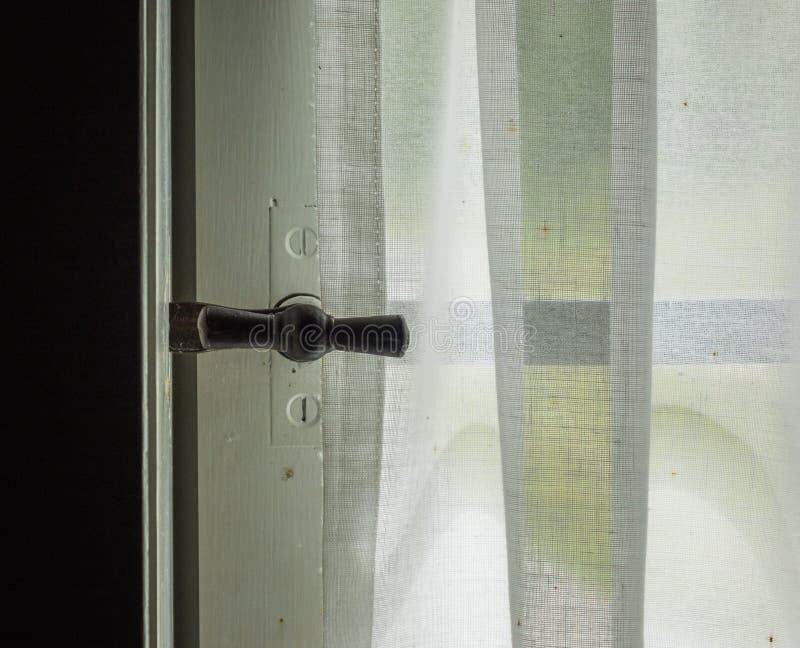 The window with curtain of an old farmhouse inside. The window with curtain of an old farmhouse inside.