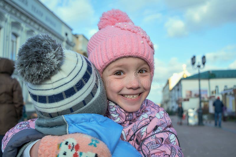 La fille étreint le garçon et les sourires et est heureuse photographie stock La fille étreint le garçon et les sourires et est heureuse photographie stock