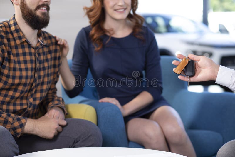 La foto potata di una coppia che è passata con l'automobile digita uno showro immagini stock libere da diritti La foto potata di una coppia che è passata con l'automobile digita uno showro immagini stock libere da diritti