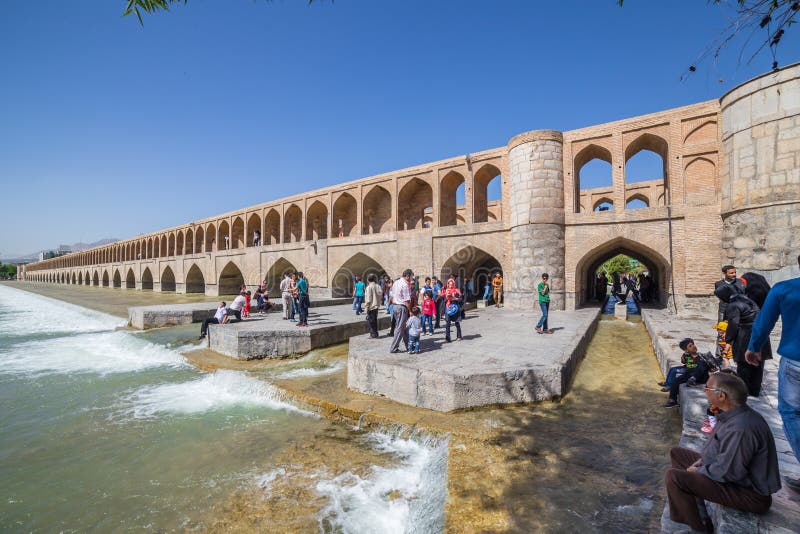 ISFAHAN, IRAN - APRIL 28, 2015: unidentified people resting in the ancient bridge Si-o-Seh Pol, The Bridge of 33 Arches, in Isfahan, Iran. ISFAHAN, IRAN - APRIL 28, 2015: unidentified people resting in the ancient bridge Si-o-Seh Pol, The Bridge of 33 Arches, in Isfahan, Iran