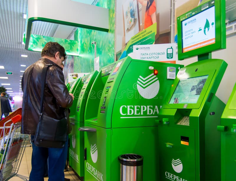 La gente sta al ATMs di Sberbank della Russia fotografia stock